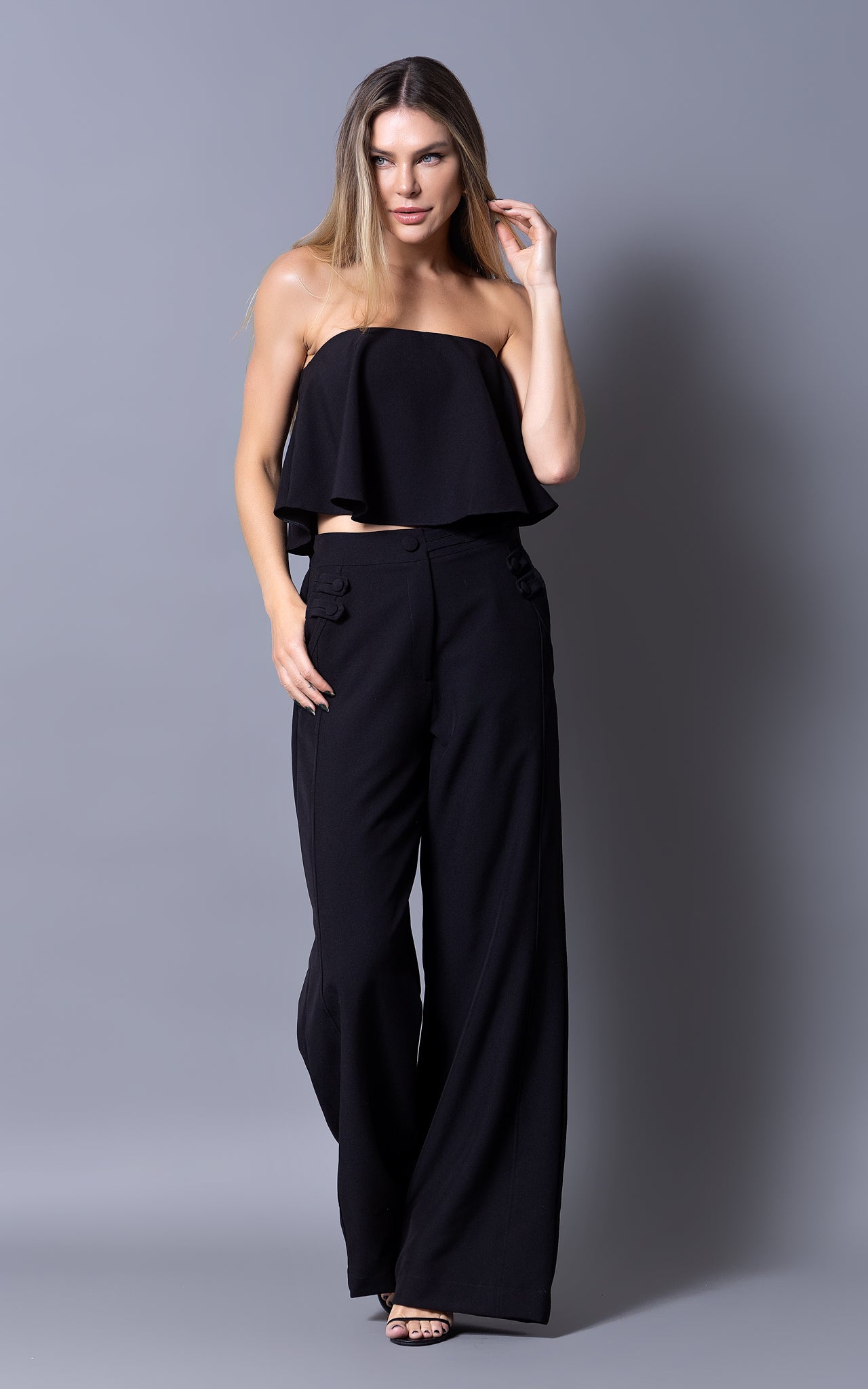 set in black wide pants and cropped top 